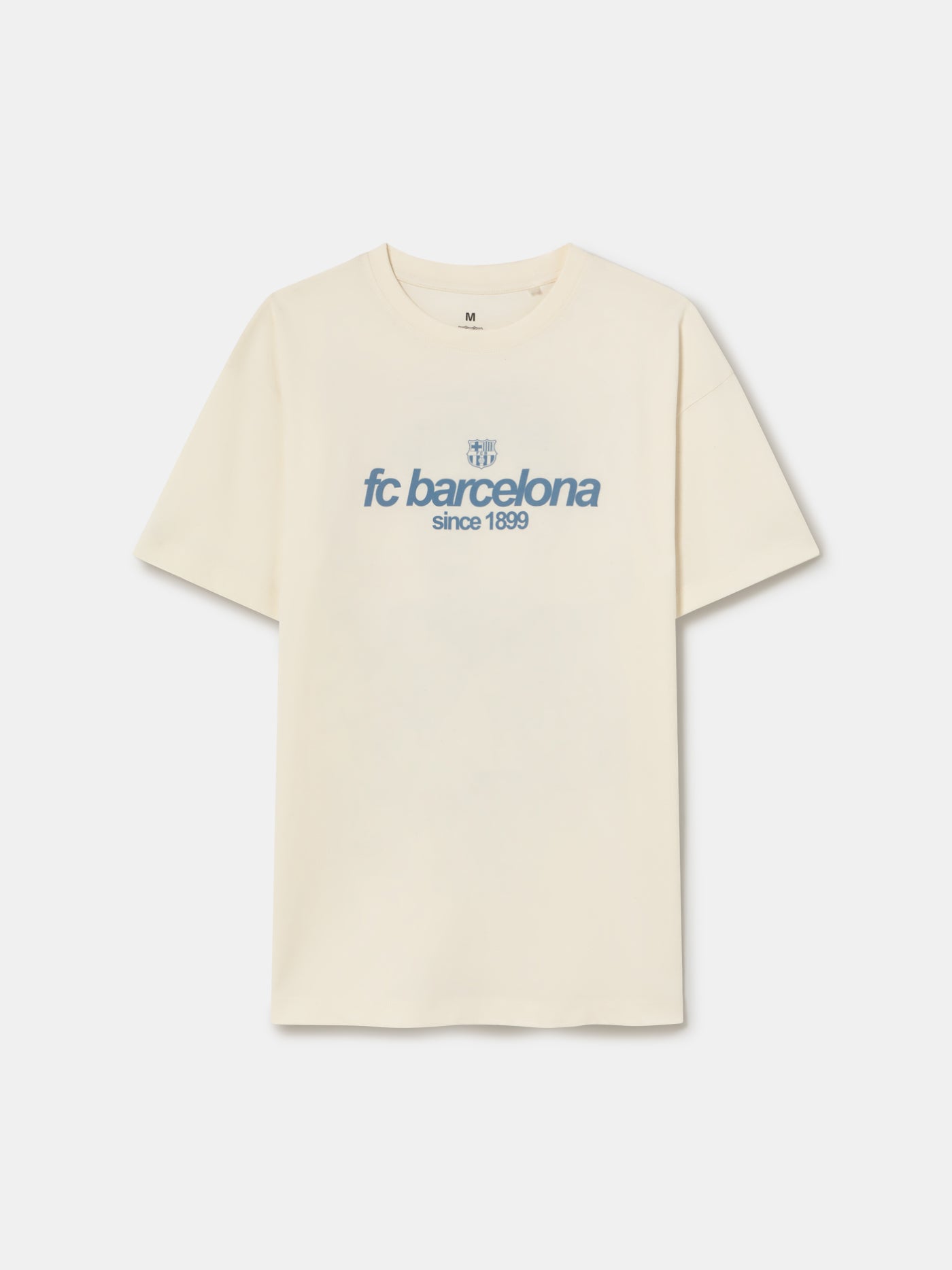 Off-white T-shirt featuring an illustrated graphic of Lamine Yamal with FC Barcelona elements and 'fc barcelona' text on the back.