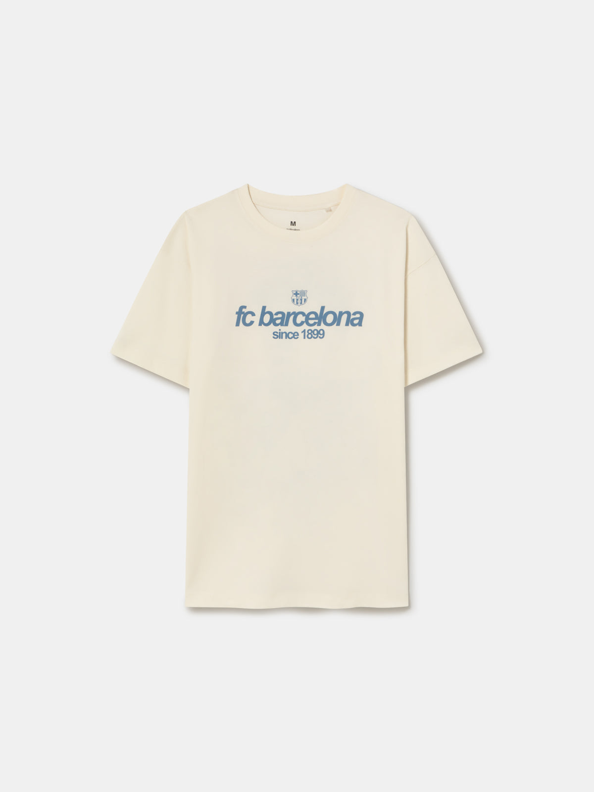 Off-white T-shirt featuring an illustrated graphic of Lamine Yamal with FC Barcelona elements and 'fc barcelona' text on the back.
