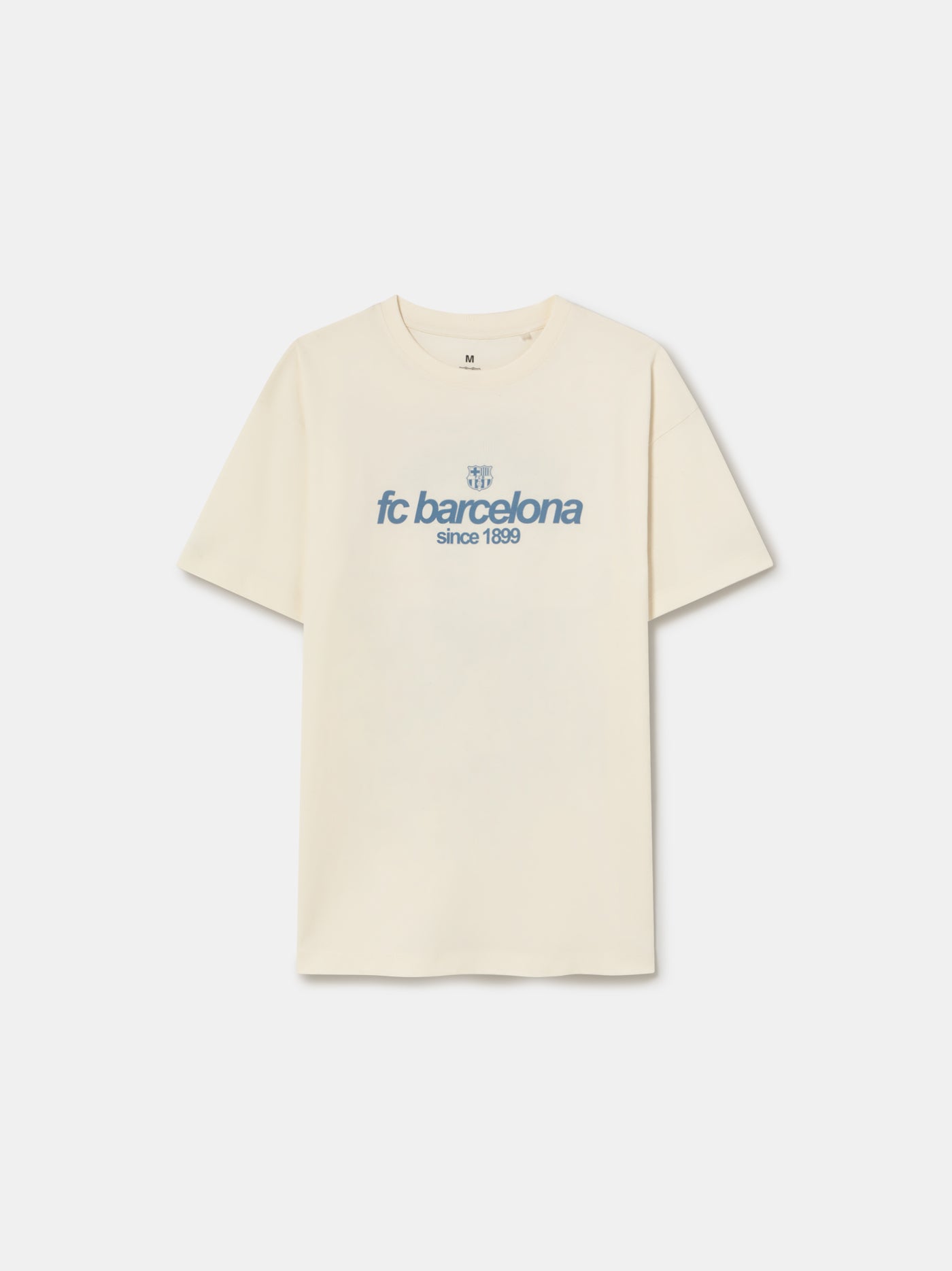 Off-white T-shirt featuring an illustrated graphic of Lamine Yamal with FC Barcelona elements and 'fc barcelona' text on the back.