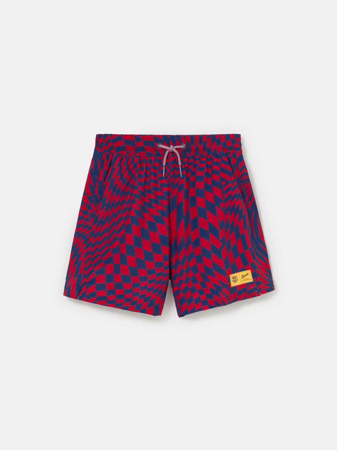 FC Barcelona-themed swim shorts featuring an eye-catching red and blue optical illusion checker pattern, elastic waistband with drawstring, side pockets, and a yellow patch label near the hem.
