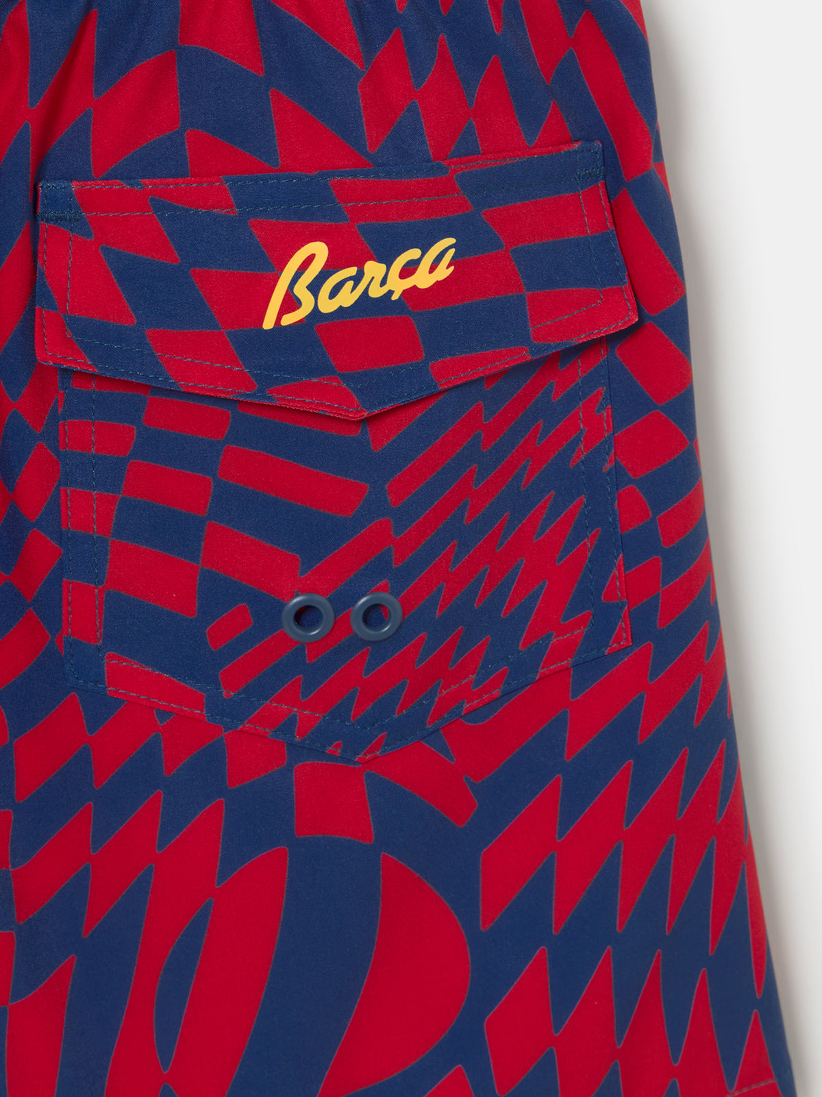 FC Barcelona-themed swim shorts featuring an eye-catching red and blue optical illusion checker pattern, elastic waistband with drawstring, side pockets, and a yellow patch label near the hem.