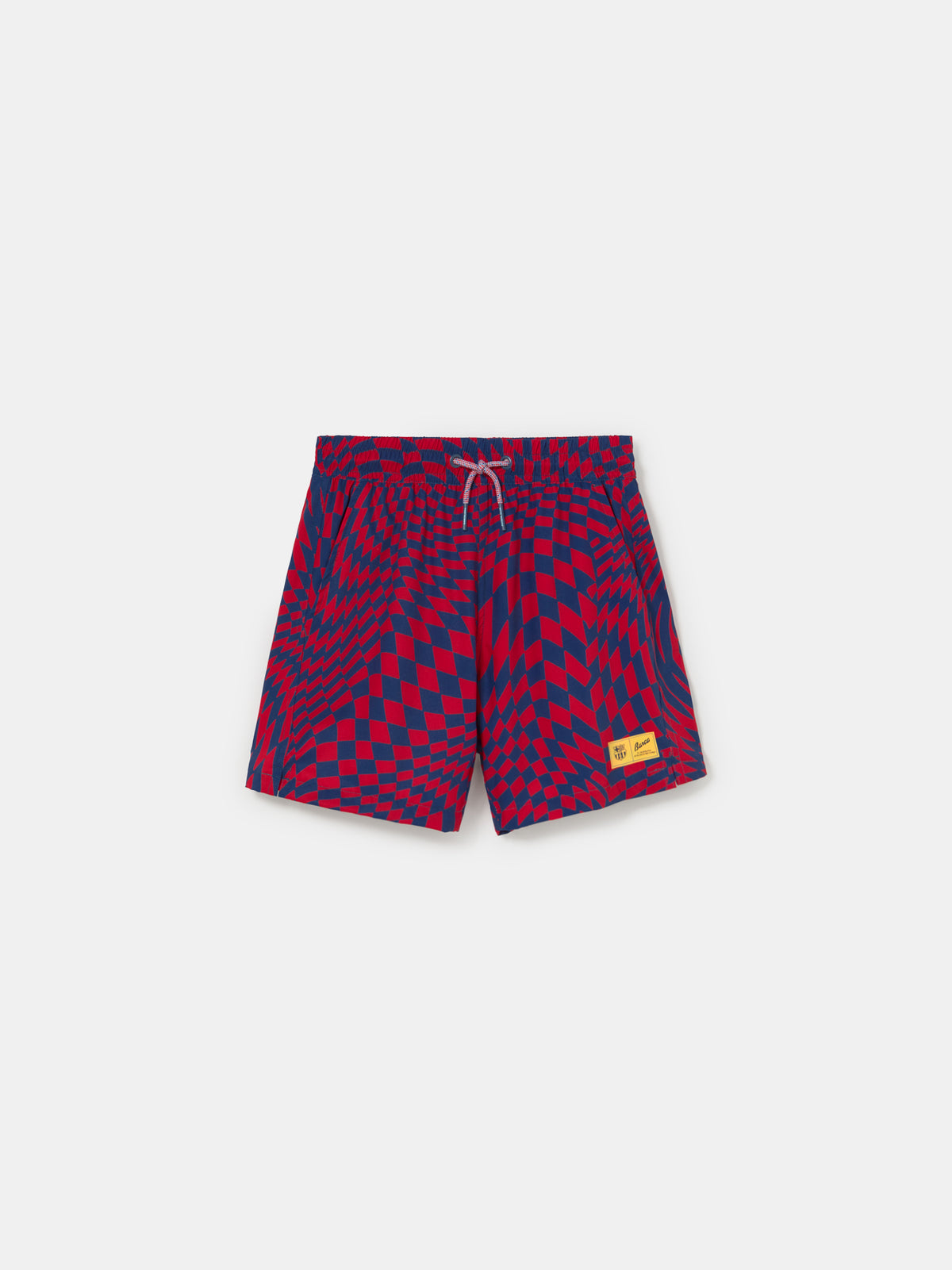 FC Barcelona swim shorts with a bold red and blue optical illusion checkerboard pattern, featuring an elastic waistband with drawstring and a yellow patch logo near the hem.