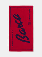 Red FC Barcelona towel featuring the word "Barça" in large navy script, with "TOTS UNITS FEM FORÇA" vertically on the left and "FC BARCELONA" with club crest on the right side
