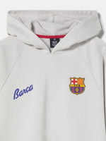 Light beige hoodie featuring a graphic of five interlocking circles with FC Barcelona colors and symbols on the back
