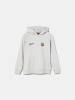White FC Barcelona hoodie featuring a unique back design with a four-petal flower made of circular emblems: the St. George cross, Catalan flag, blaugrana stripes, and a central golden football. Below the graphic, the text reads “Futbol Club Barcelona” and “Més que un club” along with minimalist logos.