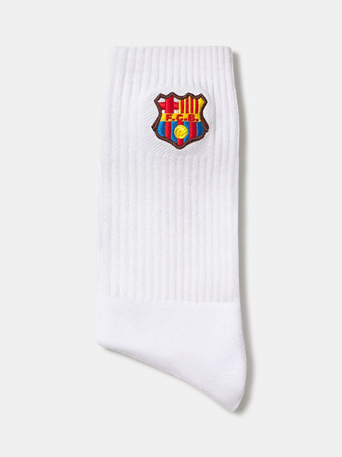 White ribbed FC Barcelona sock with the club crest embroidered near the top.