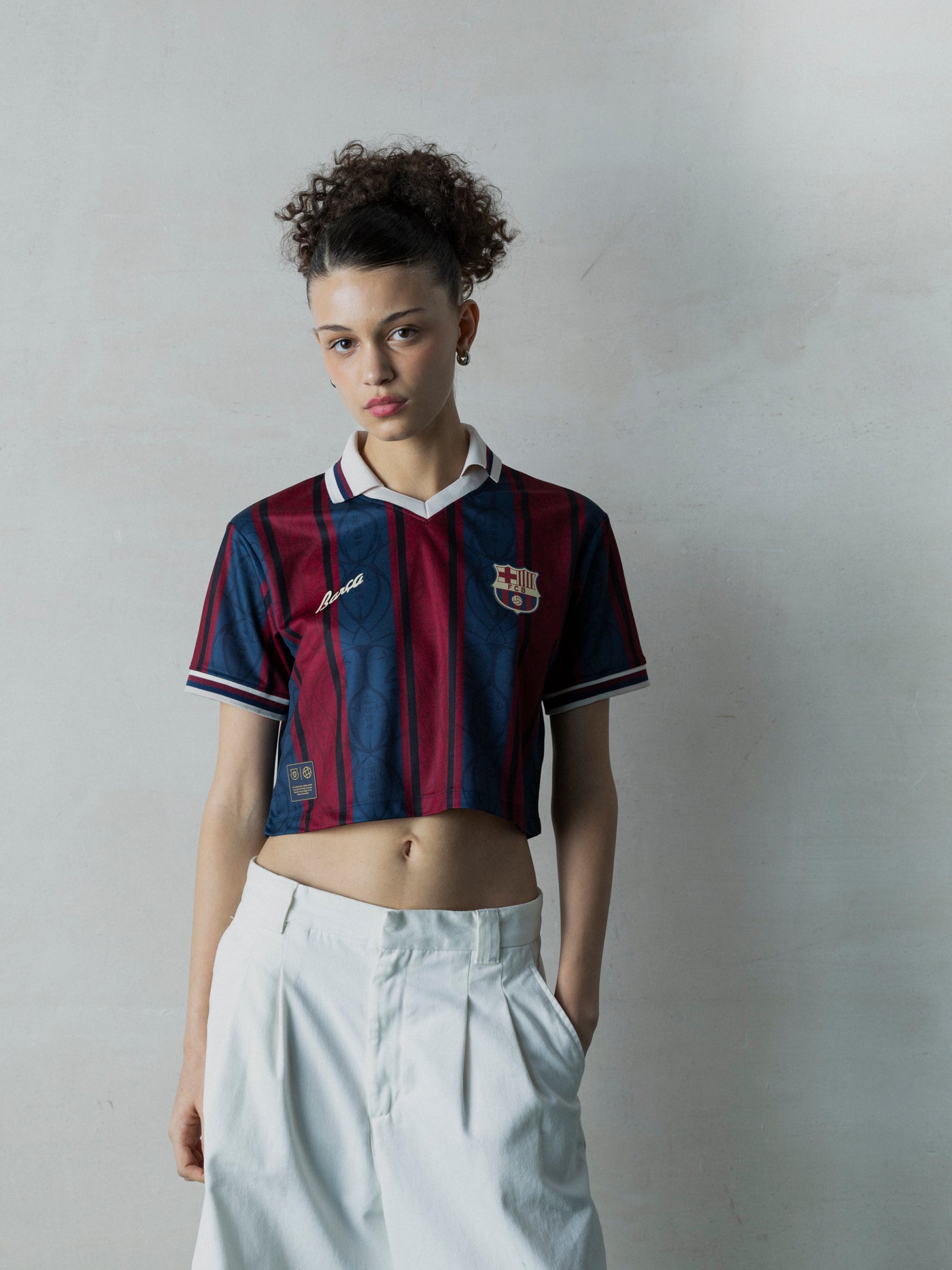 Person wearing a Barcelona jersey against a plain background