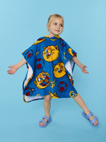 Child wearing a blue cartoon-themed poncho on a light blue background