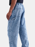 Light blue jeans worn by a person on a white background
