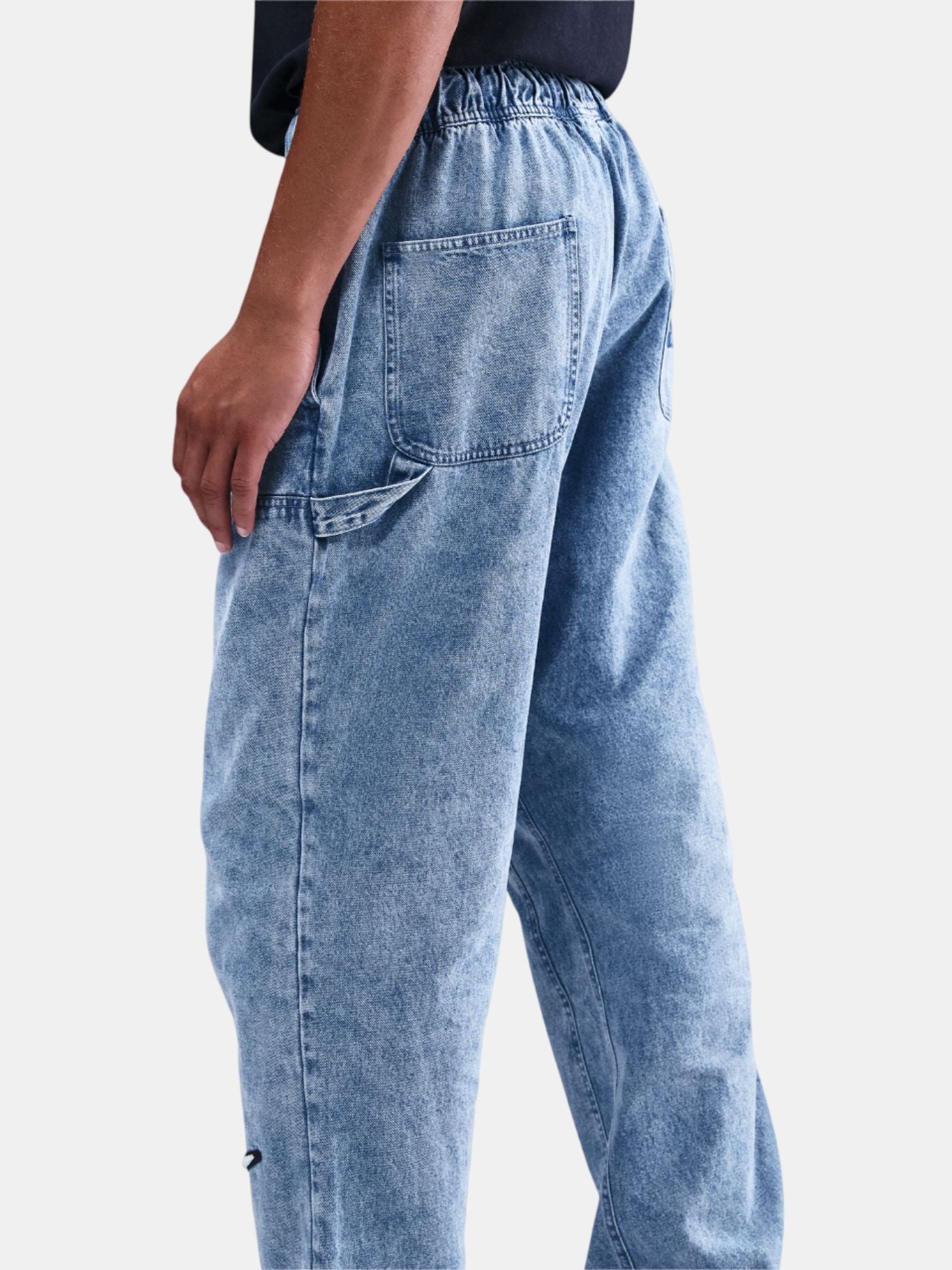 Light blue jeans worn by a person on a white background