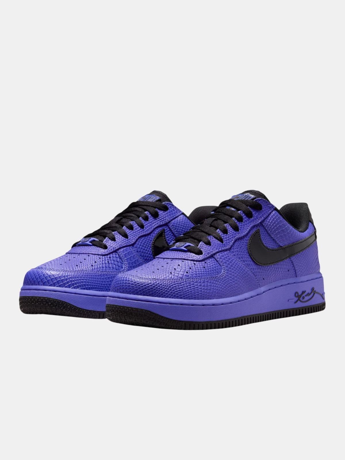 Purple sneakers with black accents on a light gray background