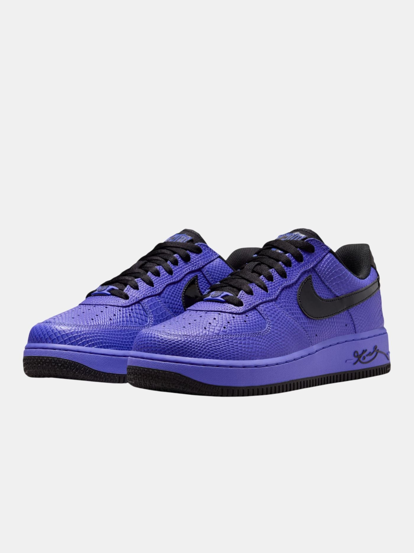 Purple sneakers with black accents on a light gray background