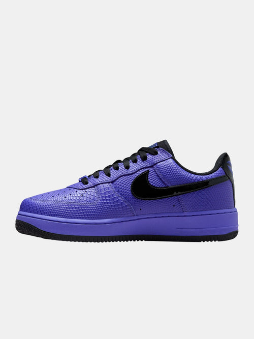 Purple sneaker with black accents on a white background