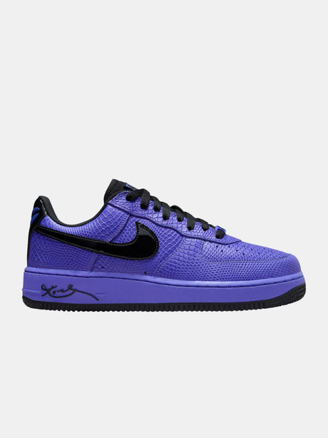 Purple sneaker with black accents on a white background