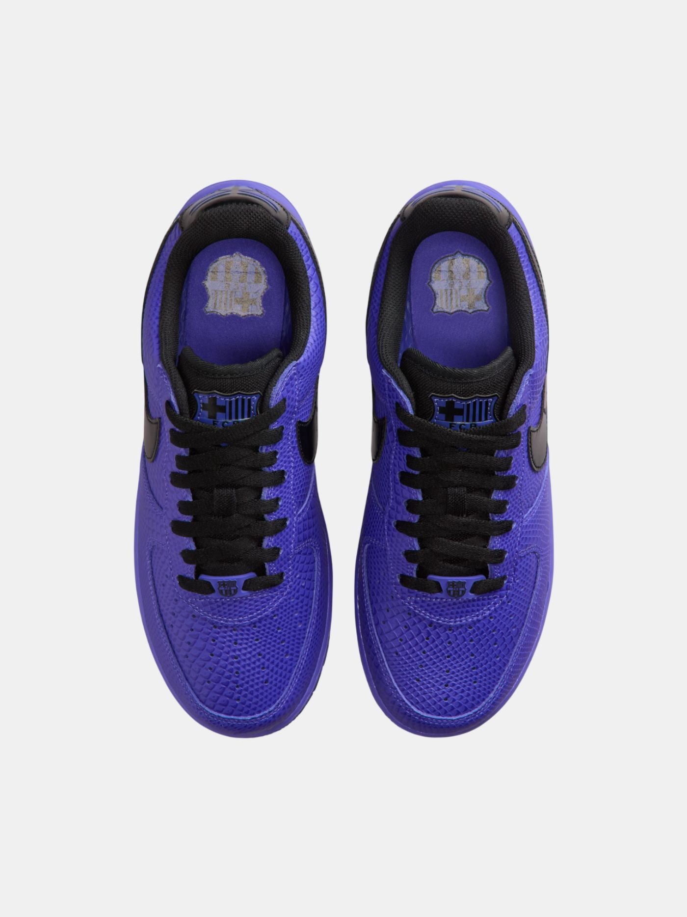 Purple sneakers with black laces on a white background