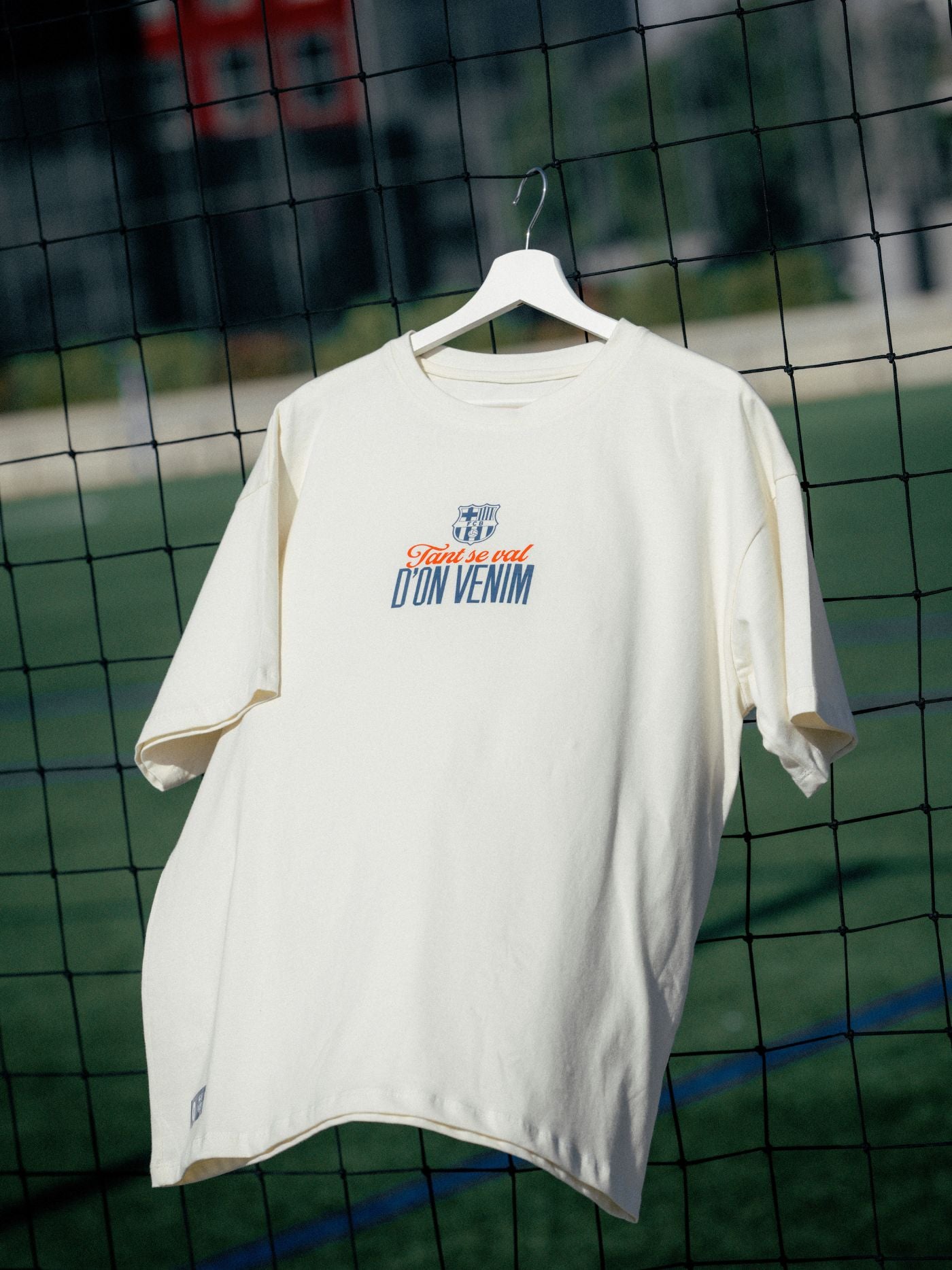 White t-shirt with text on a hanger against a grid background