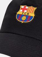 Black FC Barcelona cap with the club crest on the front and yellow Nike logo on the side