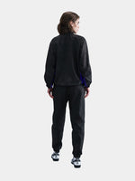 Black FC Barcelona training pants featuring the Kobe Bryant logo and 'FC Barcelona' text in purple on the right thigh.