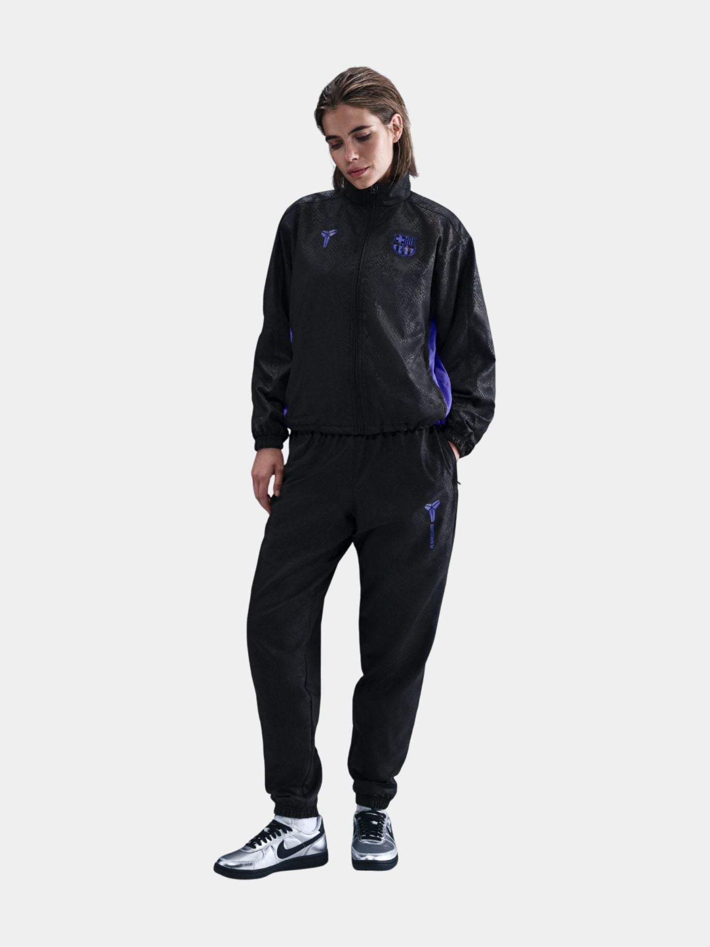Black FC Barcelona training pants featuring the Kobe Bryant logo and 'FC Barcelona' text in purple on the right thigh.