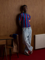 Red and blue striped FC Barcelona T-shirt with club crest on the chest and yellow Catalan armband on the sleeve