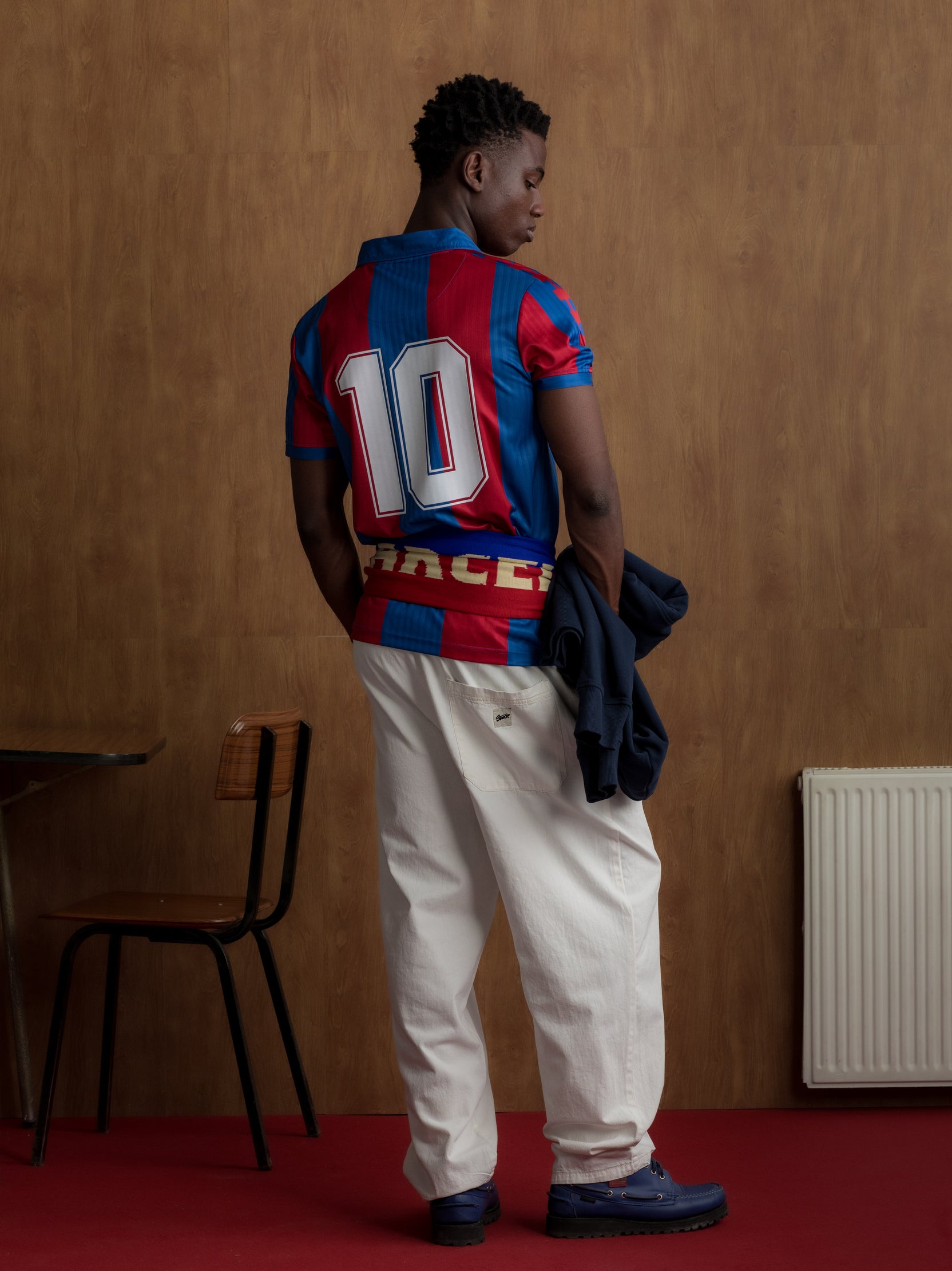 Red and blue striped FC Barcelona jersey with number 10 on the back, paired with a matching scarf around the waist.