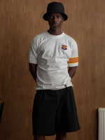 White T-shirt with FC Barcelona crest on the chest, Catalan flag detail on the sleeve, and red number 9 on the back.