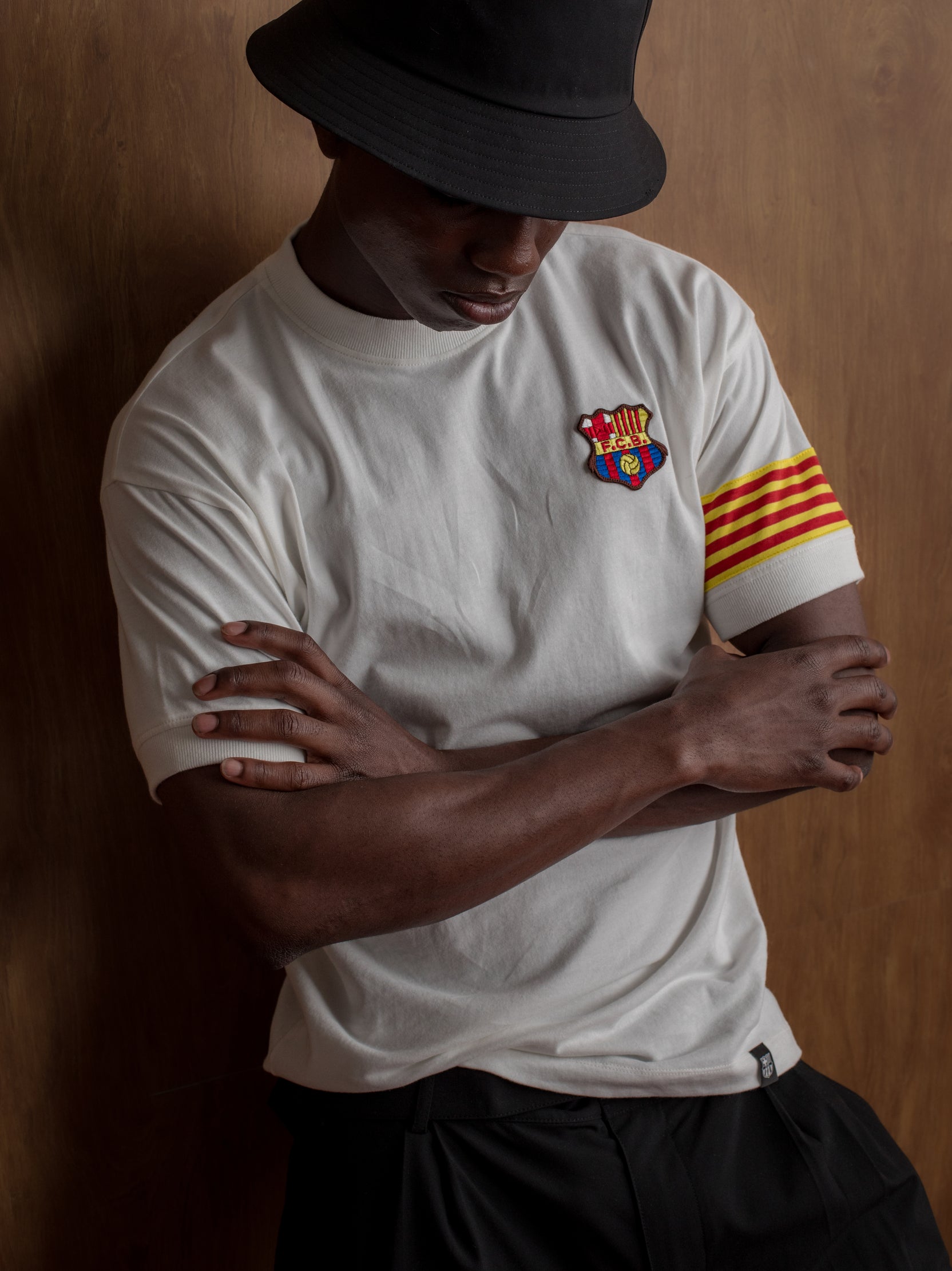 White T-shirt with FC Barcelona crest on the chest, Catalan flag detail on the sleeve, and red number 9 on the back.