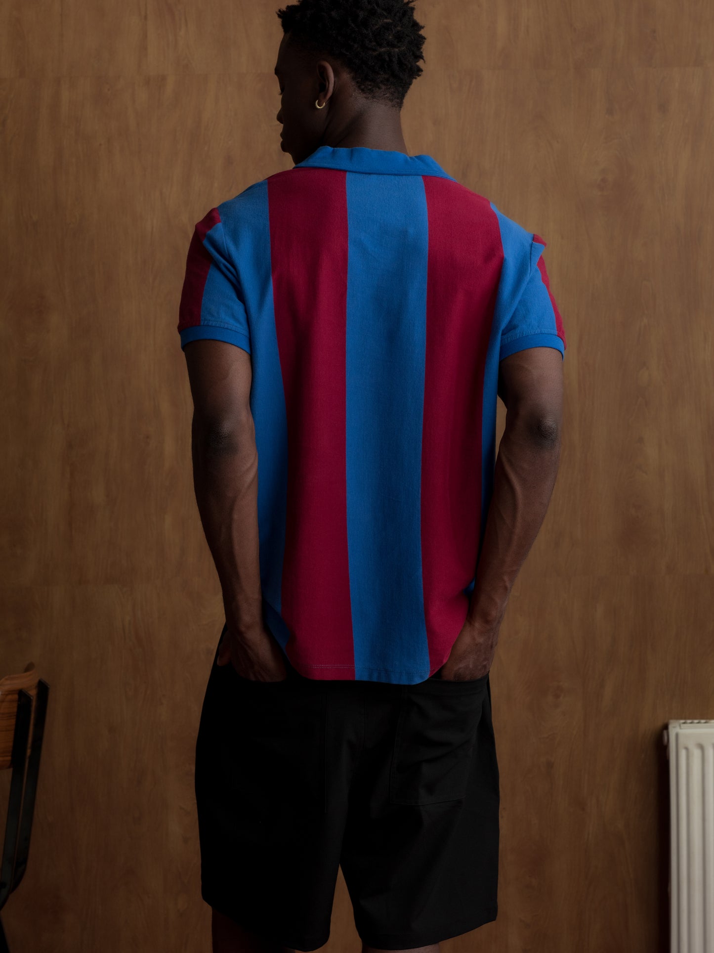 Man wearing a classic red and blue striped FC Barcelona jersey with matching scarf featuring the club crest.