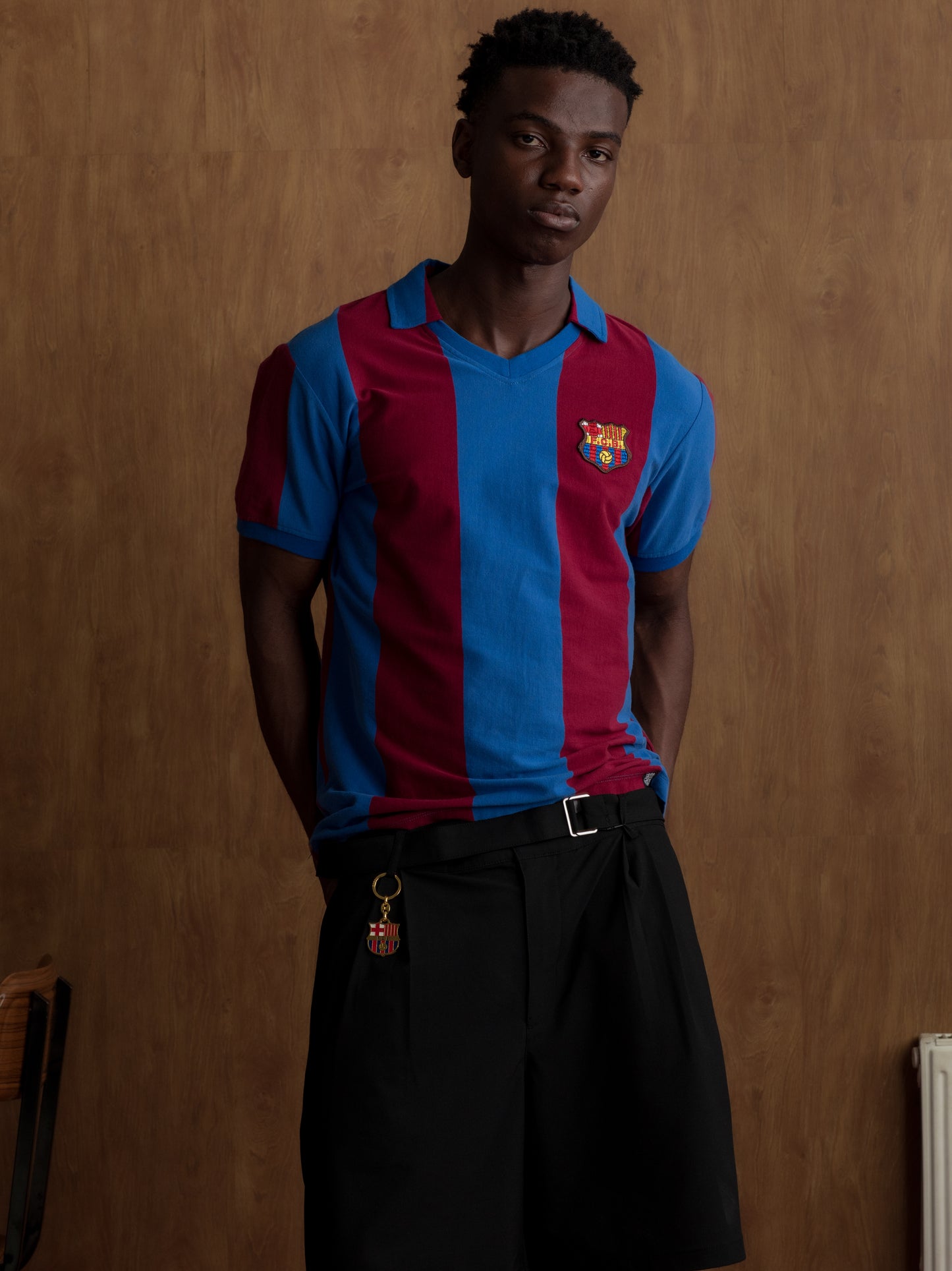 Man wearing a classic red and blue striped FC Barcelona jersey with matching scarf featuring the club crest.