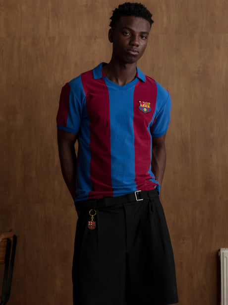 Man wearing a classic red and blue striped FC Barcelona jersey with matching scarf featuring the club crest.