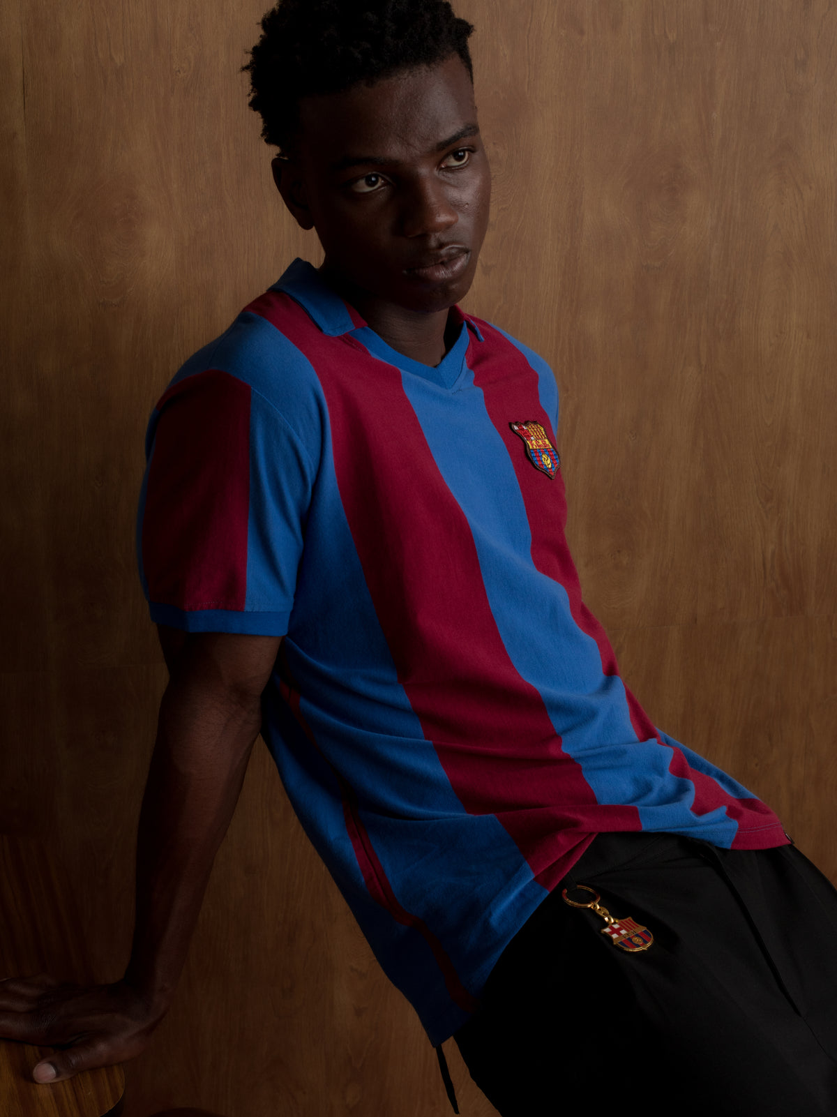 Man wearing a classic red and blue striped FC Barcelona jersey with matching scarf featuring the club crest.
