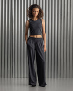 Black wide-leg pants with an elastic waistband and the FC Barcelona crest embroidered on the upper left thigh
