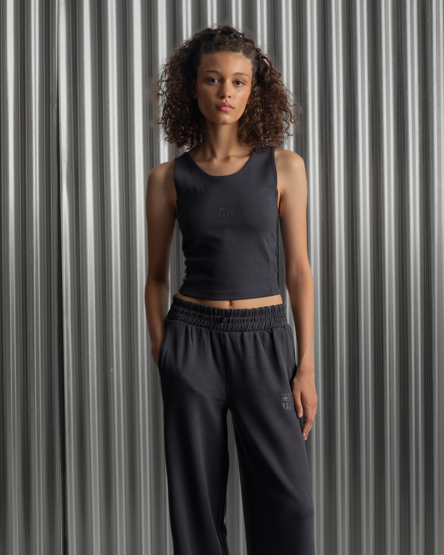 Black ribbed sleeveless crop top featuring the FC Barcelona crest embroidered in the center of the chest.