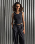 Black ribbed sleeveless crop top featuring the FC Barcelona crest embroidered in the center of the chest.