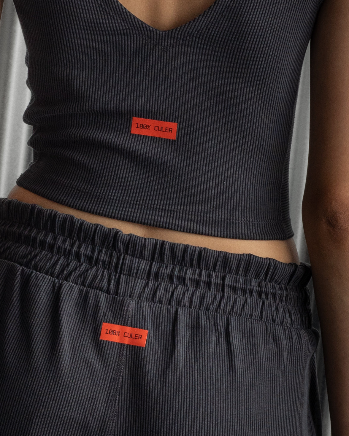 Black ribbed sleeveless crop top featuring the FC Barcelona crest embroidered in the center of the chest.