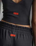 Black ribbed sleeveless crop top featuring the FC Barcelona crest embroidered in the center of the chest.