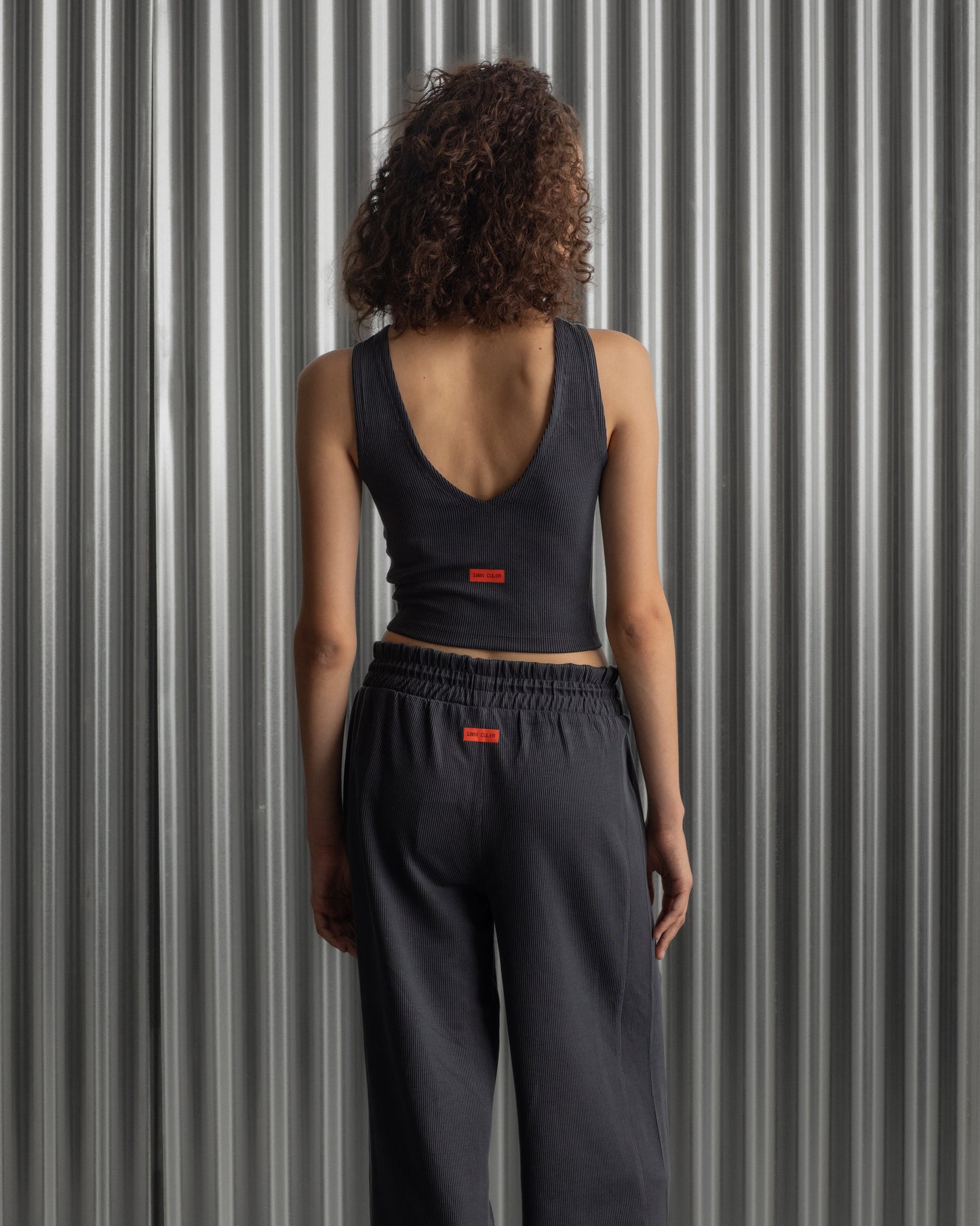 Black ribbed sleeveless crop top featuring the FC Barcelona crest embroidered in the center of the chest.