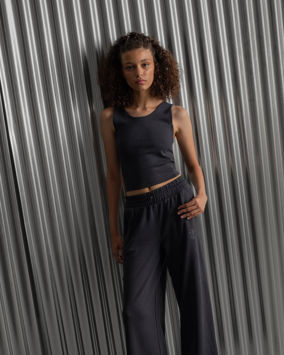 Black ribbed sleeveless crop top featuring the FC Barcelona crest embroidered in the center of the chest.