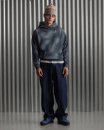 Man wearing a dark blue FC Barcelona hoodie with golden minimalist 'Barça' symbols printed on the chest