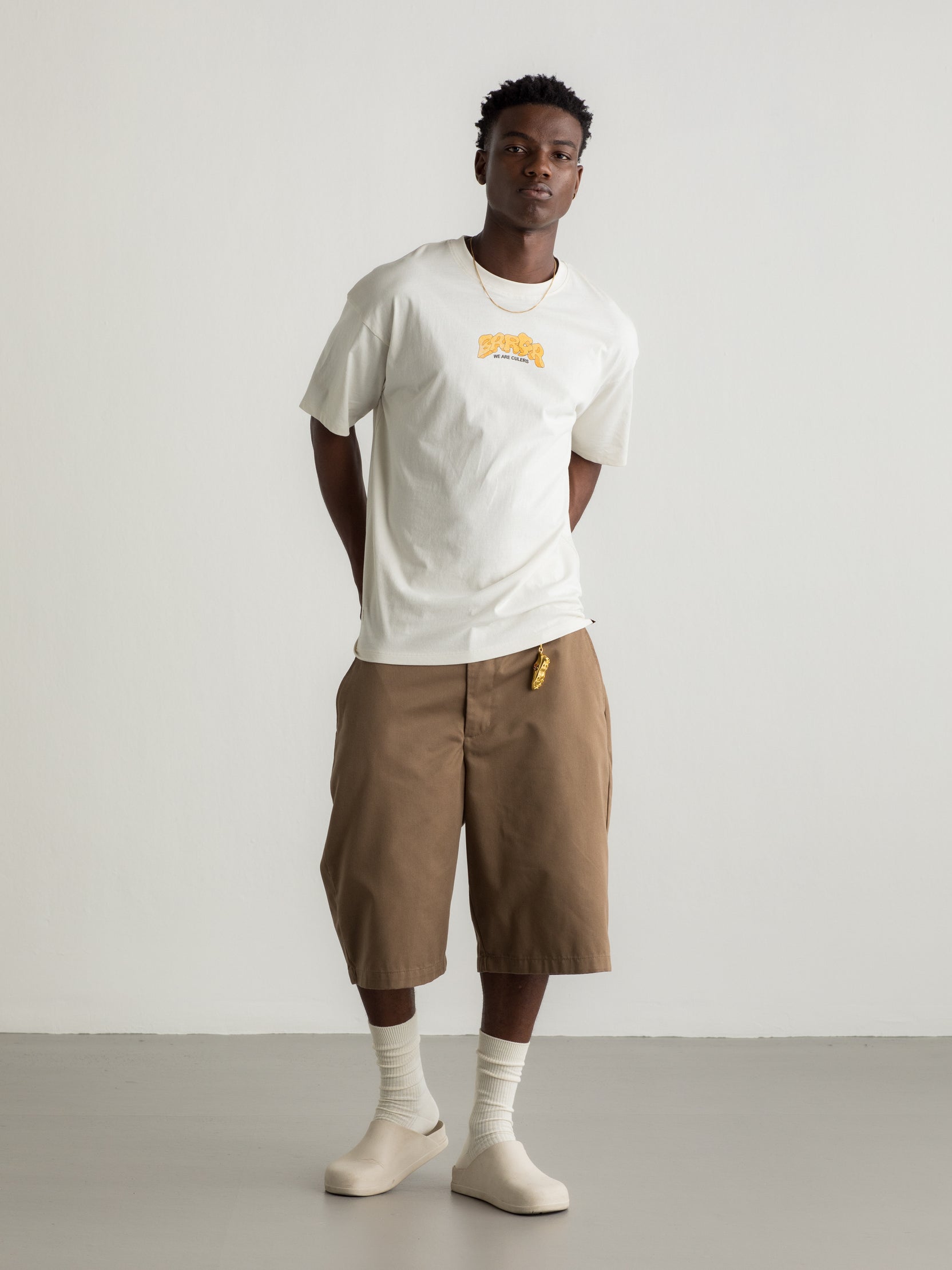 White T-shirt with colorful Barça graphic on the back featuring a football, flags, and dynamic typography