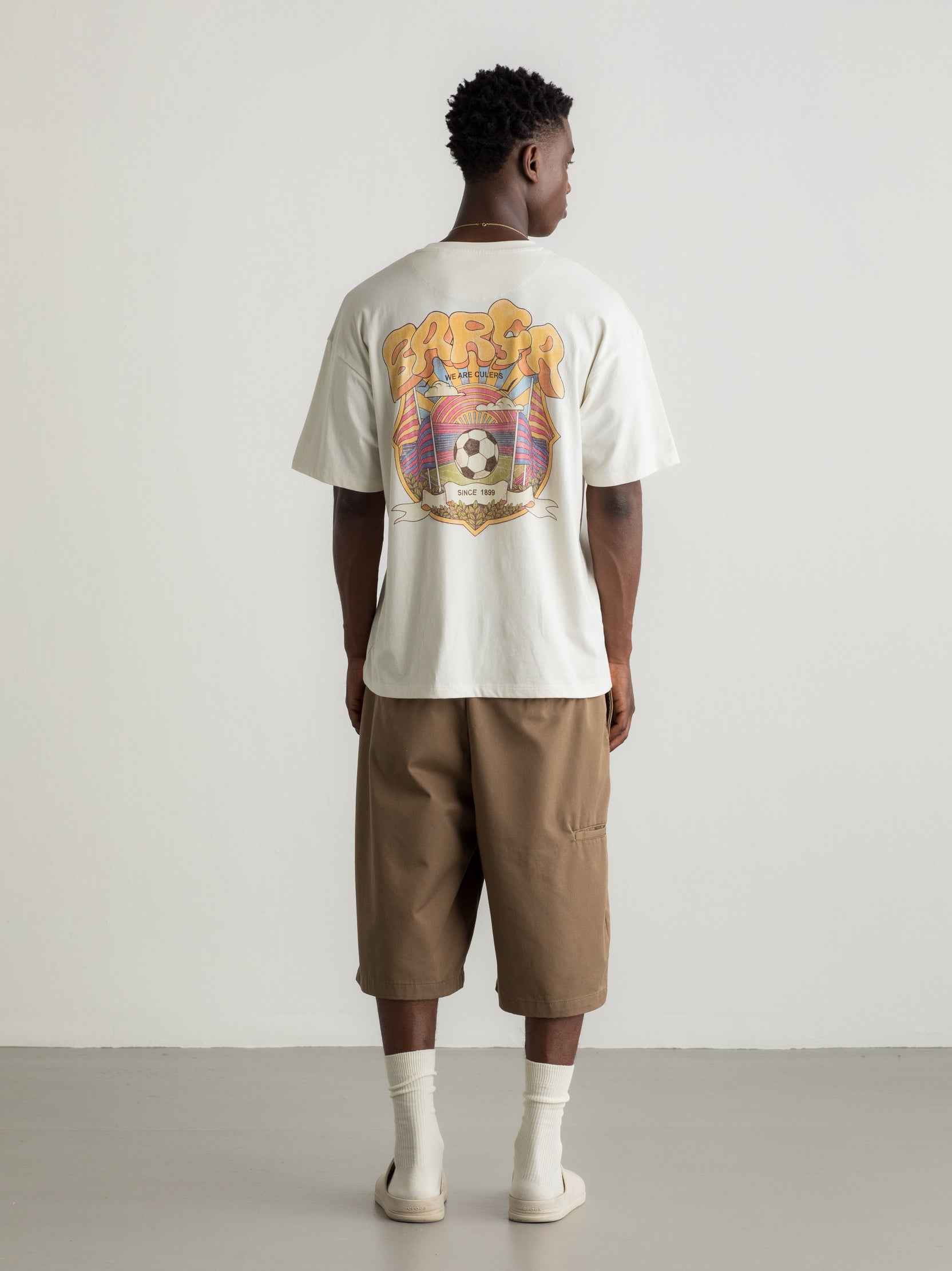 White T-shirt with colorful Barça graphic on the back featuring a football, flags, and dynamic typography