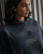 Dark blue FC Barcelona hoodie featuring the club crest and the phrase 'Good Game Lover’s Crew' embroidered on the front.