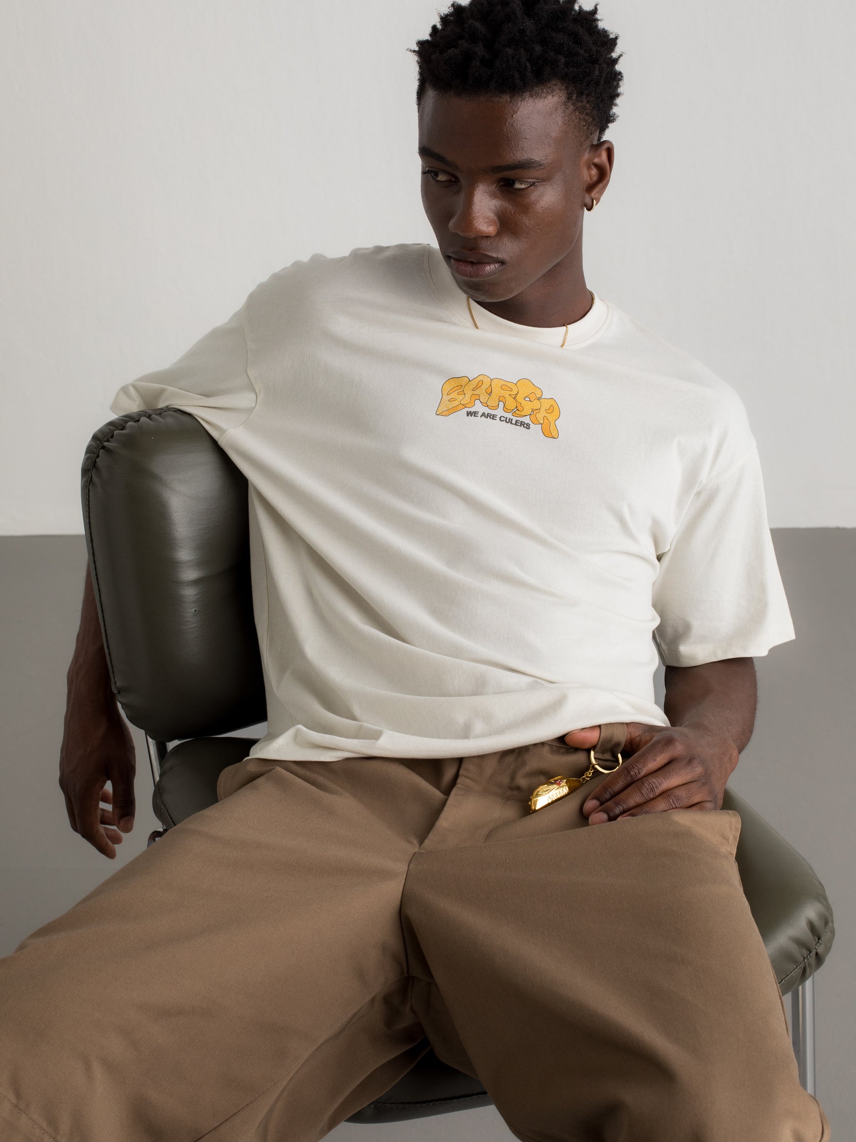 White T-shirt with colorful Barça graphic on the back featuring a football, flags, and dynamic typography