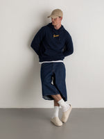 Navy hoodie with FC Barcelona crest and 'Més que un club' slogan printed on the back.