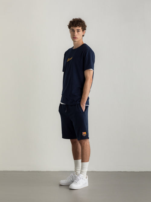 Navy T-shirt with FC Barcelona crest and 'Més que un club' slogan printed on the back.