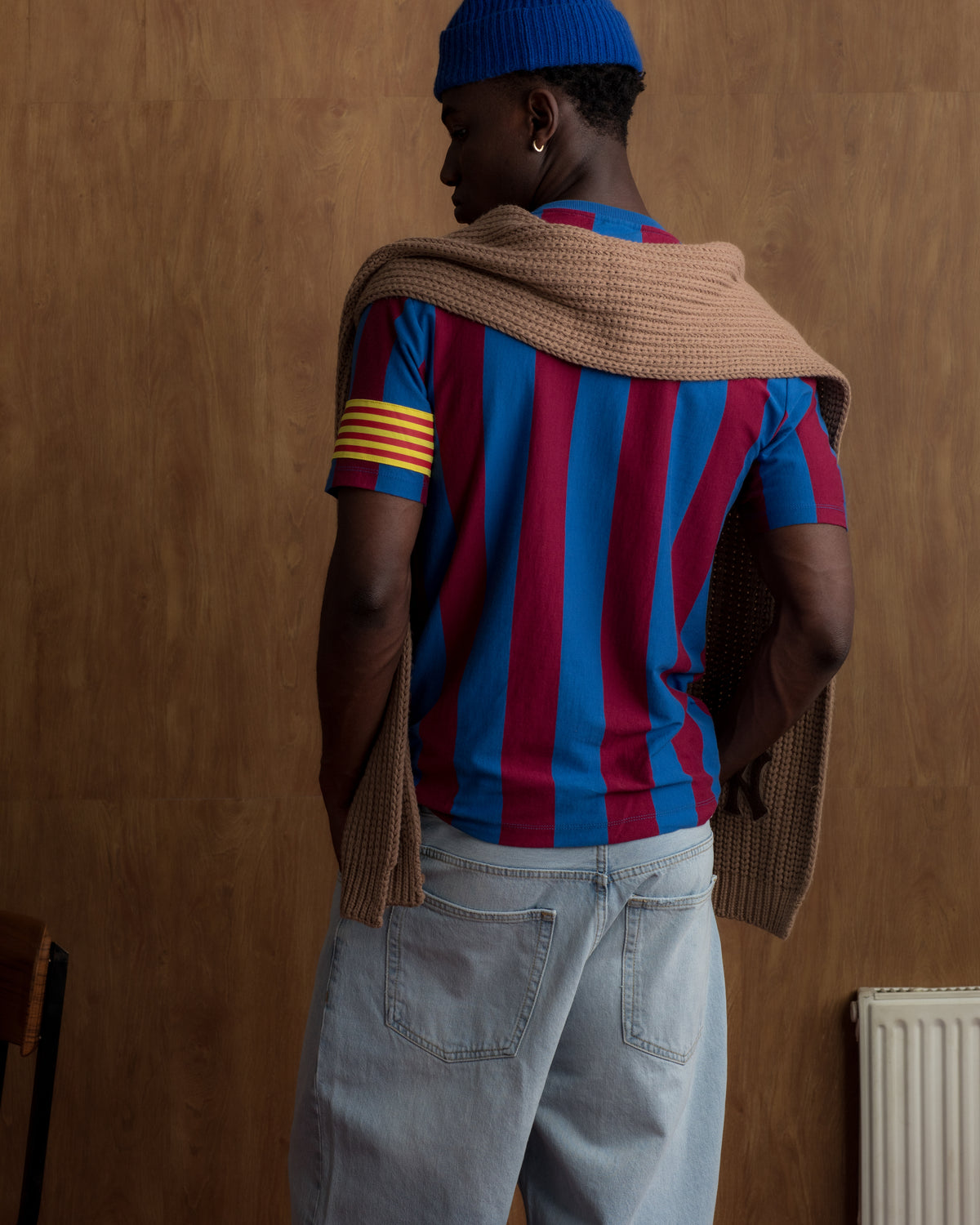 Red and blue striped FC Barcelona T-shirt with club crest on the chest and yellow Catalan armband on the sleeve