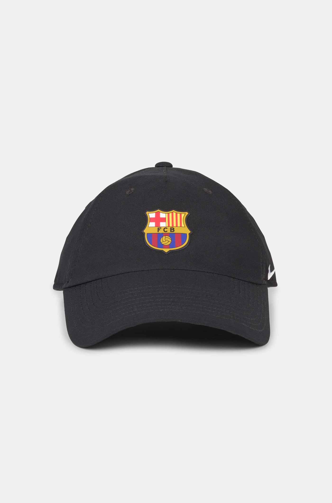 Black curved-brim cap featuring the FC Barcelona crest on the front and a white Nike swoosh embroidered on the side.
