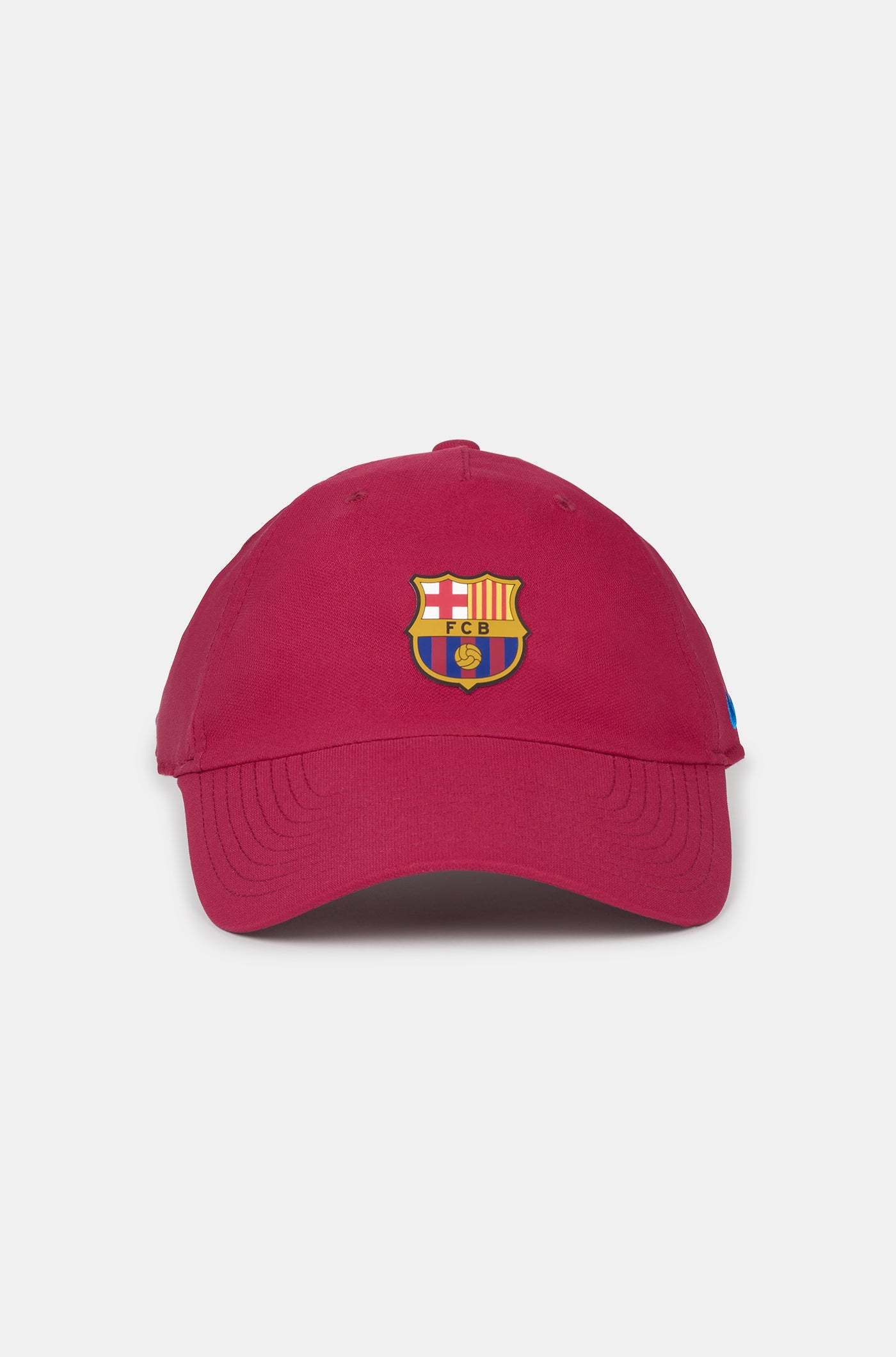 Red curved-brim cap featuring the FC Barcelona crest on the front and a blue Nike swoosh embroidered on the side.