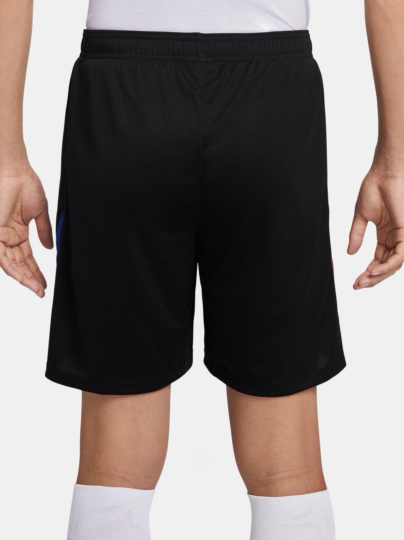 Black FC Barcelona shorts with blue and red side accents, Nike logo and club crest.