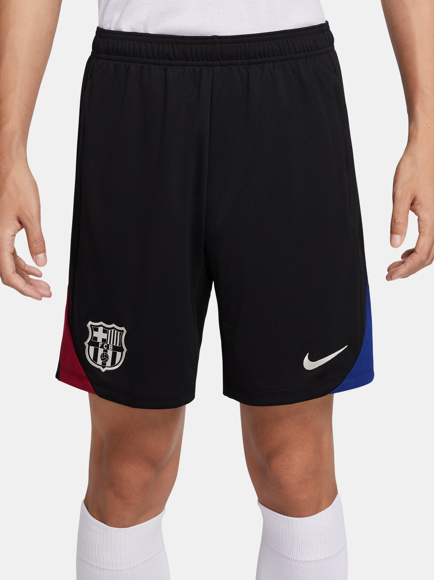 Black FC Barcelona shorts with blue and red side accents, Nike logo and club crest.
